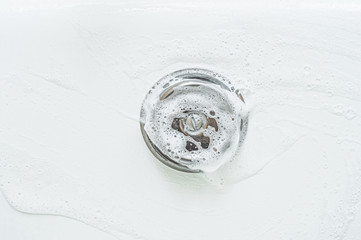 Lathering an iron element in the bathroom with thick foam