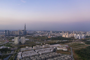 Obraz premium Aerial view to new luxury real estate developments along the Saigon river from Thu Thiem district, in Ho Chi Minh City, Vietnam at twilight