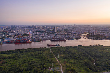 Aerial shot of Saigon river and shipping port from high angle at twilight. Ho Chi Minh City is the financial capital of Vietnam