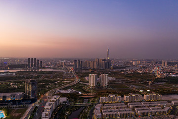 Fototapeta premium Aerial view to new luxury real estate developments along the Saigon river from Thu Thiem district, in Ho Chi Minh City, Vietnam at twilight