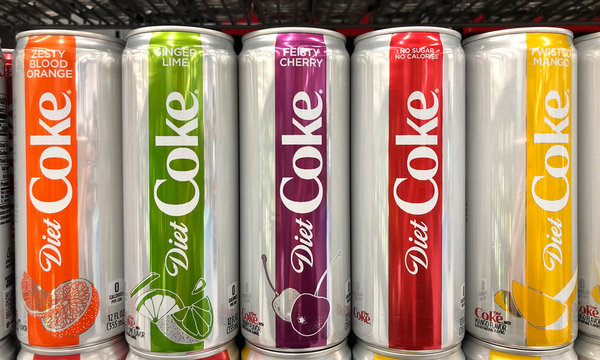 Alameda, CA - February 09, 2018: Grocery Store shelf with cans of flavored Diet Coke. Ginger Lime, Feisty Cherry, Zesty Blood Orange and Twisted Mango bring more variety to the trademark coke brand.