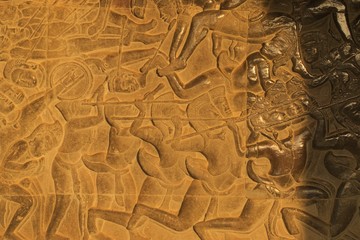 Ancient bas-relief on a wall of Angkor Wat temple, depicting Khmer soldiers engaging in battle.