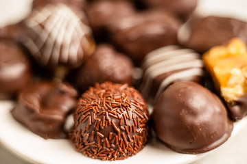 Dark chocolates, shallow depth of field focus on a sprinkly chocolate treat