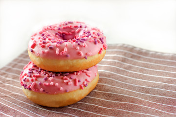 Donuts with pink icing and marshmellow. unhealthy food concept. dougnuts on thr table