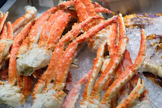 Close up big giant King crab legs on iced selling in japan market , food and travel concept.