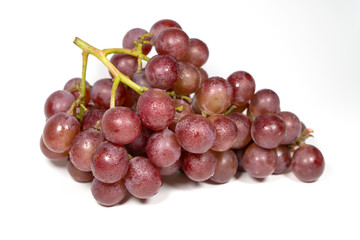Purple grapes on white background..