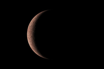 A little planet with light from the sun shining just a little from behind the left side in the dark. 3D rendering