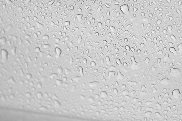 Water​ rain​ drops​ on​ white fabric tent​s background