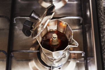 Closeup of Moka coffee pot on a gas stove - zenith view