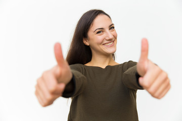 Beautiful smiling woman showing thumbs up. Cheerful lady looking at camera and gesturing....