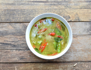 Thai food chicken green curry on dark wooden background. top view