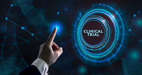 Business, Technology, Internet and network concept. Business man working on the tablet of the future, select on the virtual display: Clinical trial