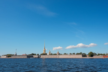 Naklejka premium St. Petersburg, Neva, Peter and Paul fortress, Russia. Summer urban landscape of the Northern capital of Russia.Beautiful view on a Sunny day, the Neva river and beautiful blue sky. Copyspace. Travel