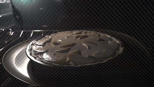 Timelapse of baking apple pie in the oven.