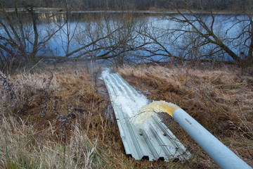 Industrial waste is discharged into the river. Nature pollution by industrial waste. Ecology...