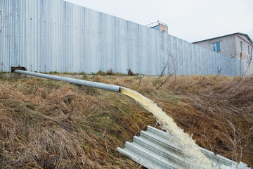Industrial waste is discharged into the river. Nature pollution by industrial waste. Ecology concept.