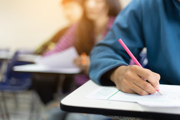 soft focus.high school,university student study.hands writing paper answer sheet.sitting lecture...