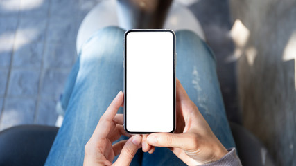 Mockup image blank white screen cell phone.man hand holding texting using mobile at coffee shop.background empty space for advertise text.people contact marketing business,technology