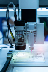 Robot holding glue syringe Injection with robotic machine vision system