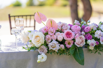 Bouquets of fresh flowers decoration of the festive table. Celebrating an open air party. Decor Details