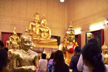 Golden statue of buddha in temple, Thailand	