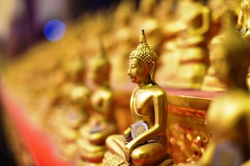 Golden statue of buddha in temple, Thailand	