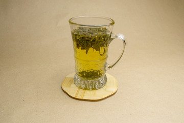 Glass cup of green tea on a stand