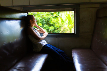 Train ride in Sri Lanka. Woman sitting and looking out the window