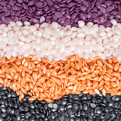 Bright colored granules. Abstract beautiful background. Granules for hair removal. Vivid colorful gold, black, white, purple pearl Wallpaper. Vibrant. Waxing wax. Spa salon