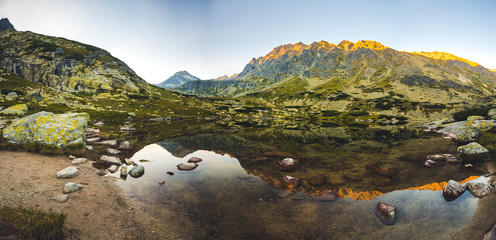 Beautiful waterfall flowing from top of a stone wall. Waterfalll Skok. Mlynicka valley with stone hiking trail. High Tatras mountains in Slovakia © Zedspider