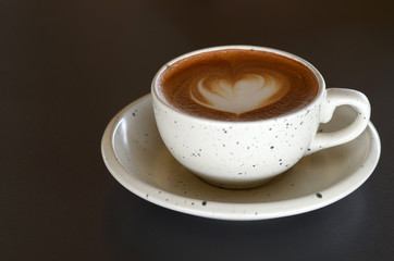 White latte coffee cup On a wooden table in a suburb cafe taking stock photos
