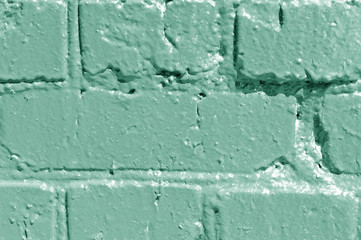 Painted brick wall close up. Abstract background green color toned