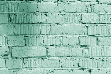 Painted brick wall close up. Abstract background green color toned