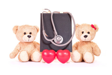 Teddy bears, red heart and stethoscope with blackboard on a white background. Health concept.