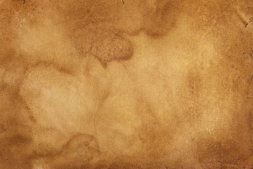 The surface of a brown crumpled stained old ancient vintage sheet of paper. Abstract trendy modern paper texture background