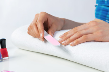 Woman using nail file and create nails shape