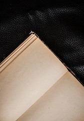 Open book blank sheets on dark background.