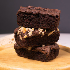 brownies with macadamia nuts on wood plate