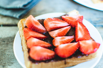 Sandwich bread chocolate spread and strawberries