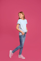 Full length portrait of preteen girl on pink background