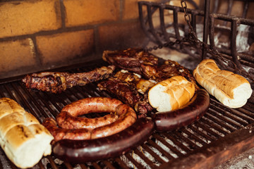 "Parrillada" Argentine barbecue make on live coal (no flame), beef "asado", bread, "Chorizo" and blood sausage "morcilla"