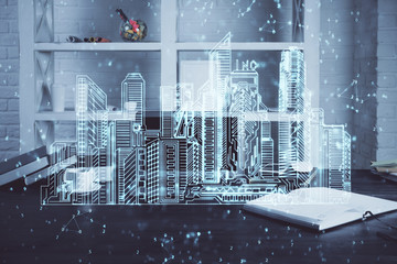Desktop computer background in office and big town buildings hologram drawing. Double exposure. Smart city concept.
