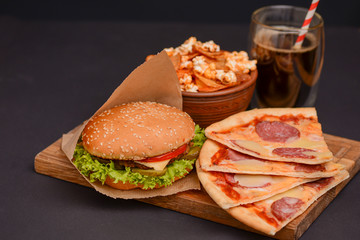 Tasty and appetizing hamburger on a darkly green background