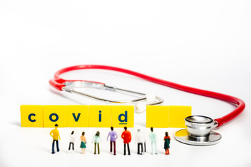 Covid-19 Coronavirus Concept - Miniature figurienes, still object on white background, shallow depth of field.