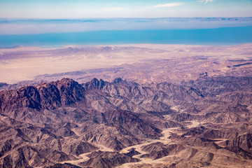 Fototapeta na wymiar Aerial view of mountains in the Sinai through an airplane window