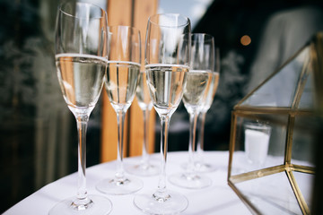 Glasses of champagne on table  for guests at the wedding ceremony. Alcohol