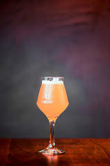 Glass of light beer on the counter table in bar. Alcohol drink. Food photography concept, copy space.