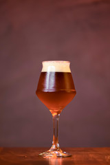 Glass of light beer on the counter table in bar. Alcohol drink. Food photography concept, copy space.