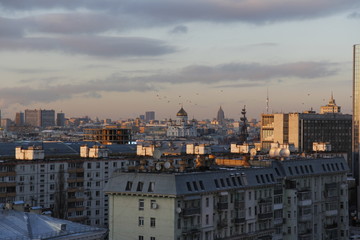 Fototapeta na wymiar Sunset panorama of Moscow with birds in the sky, winter time