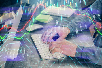 Stock graph with businessman typing on computer in office on background. Concept of analysis....